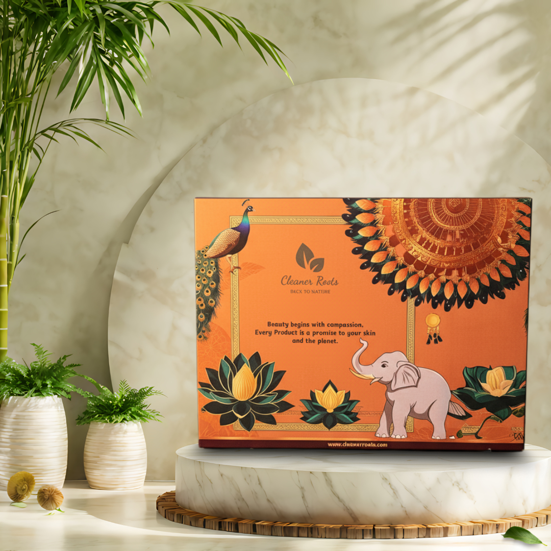 Orange box with elephant and peacock design on a decorative platform with plants.