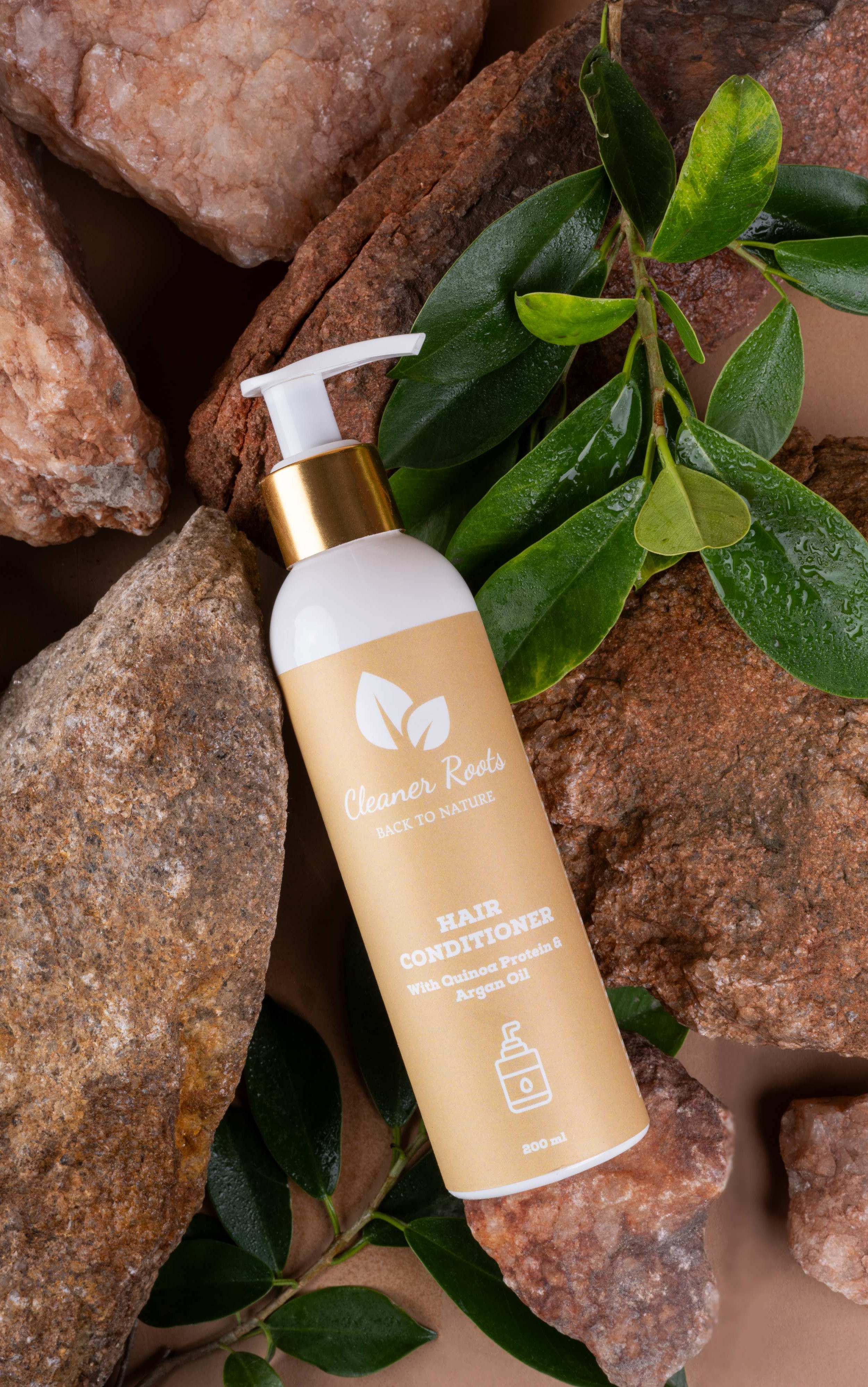 Cleaner Roots hair conditioner with quinoa protein and argan oil on natural background