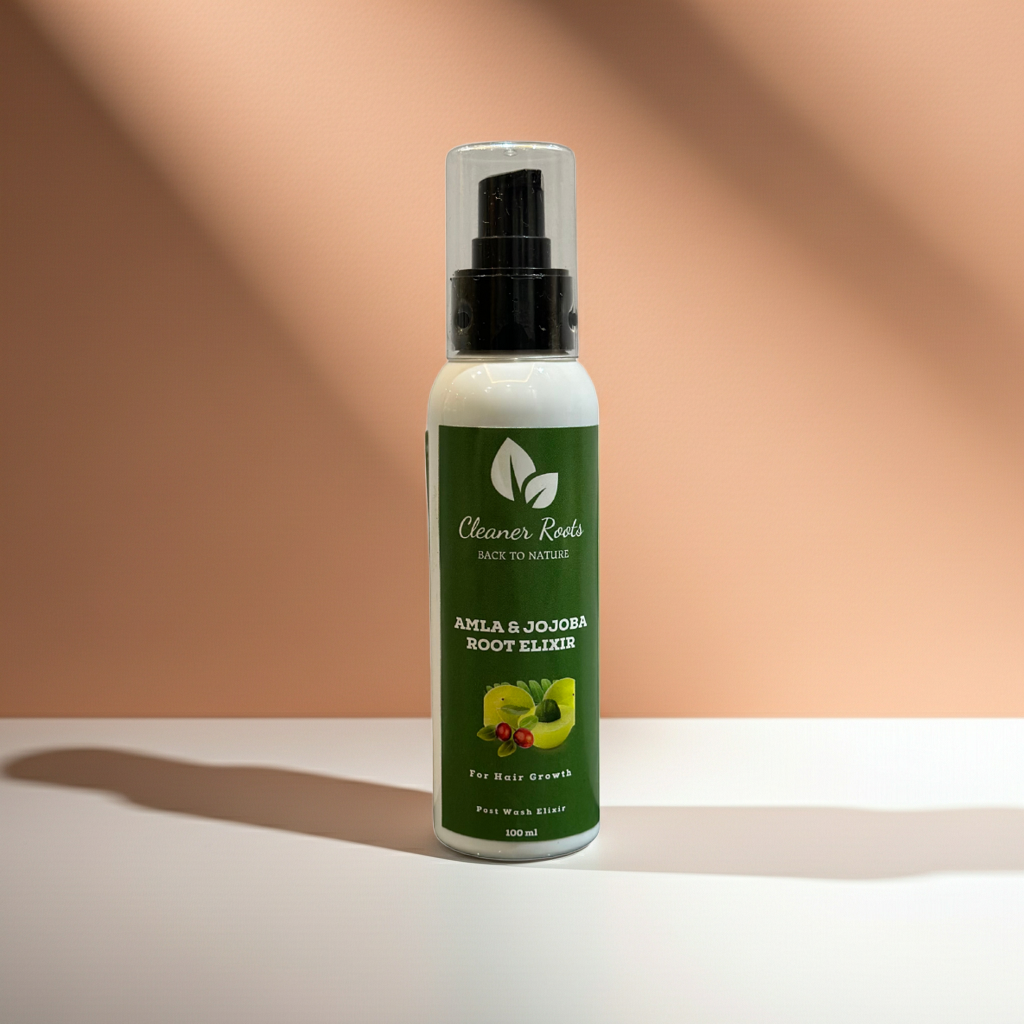 Bottle of Amla & Jojoba Root Elixir on a peach background