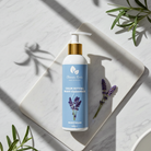 Body cleanser bottle with lavender design on a white surface with green leaves.