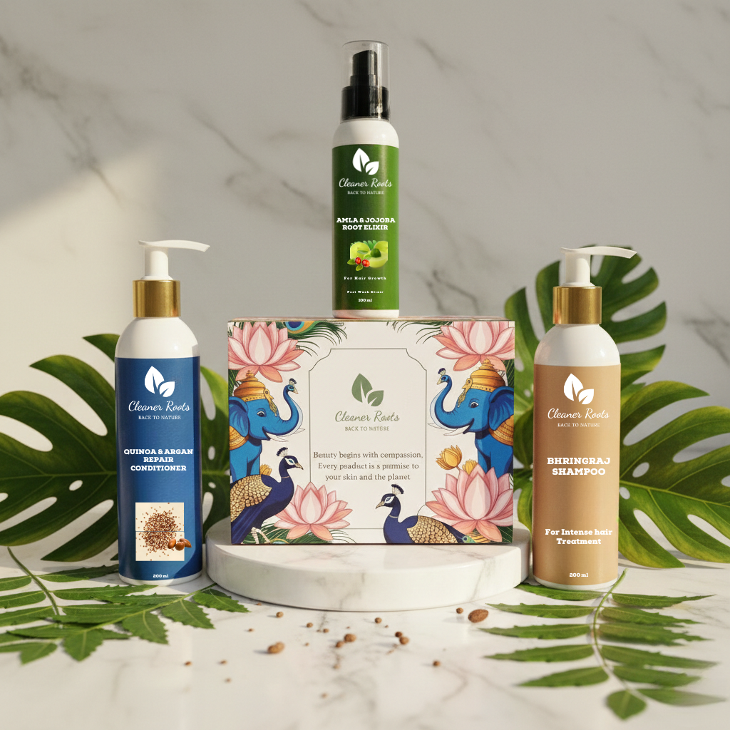 Set of skincare and hair care products with decorative packaging on a marble surface with green leaves.