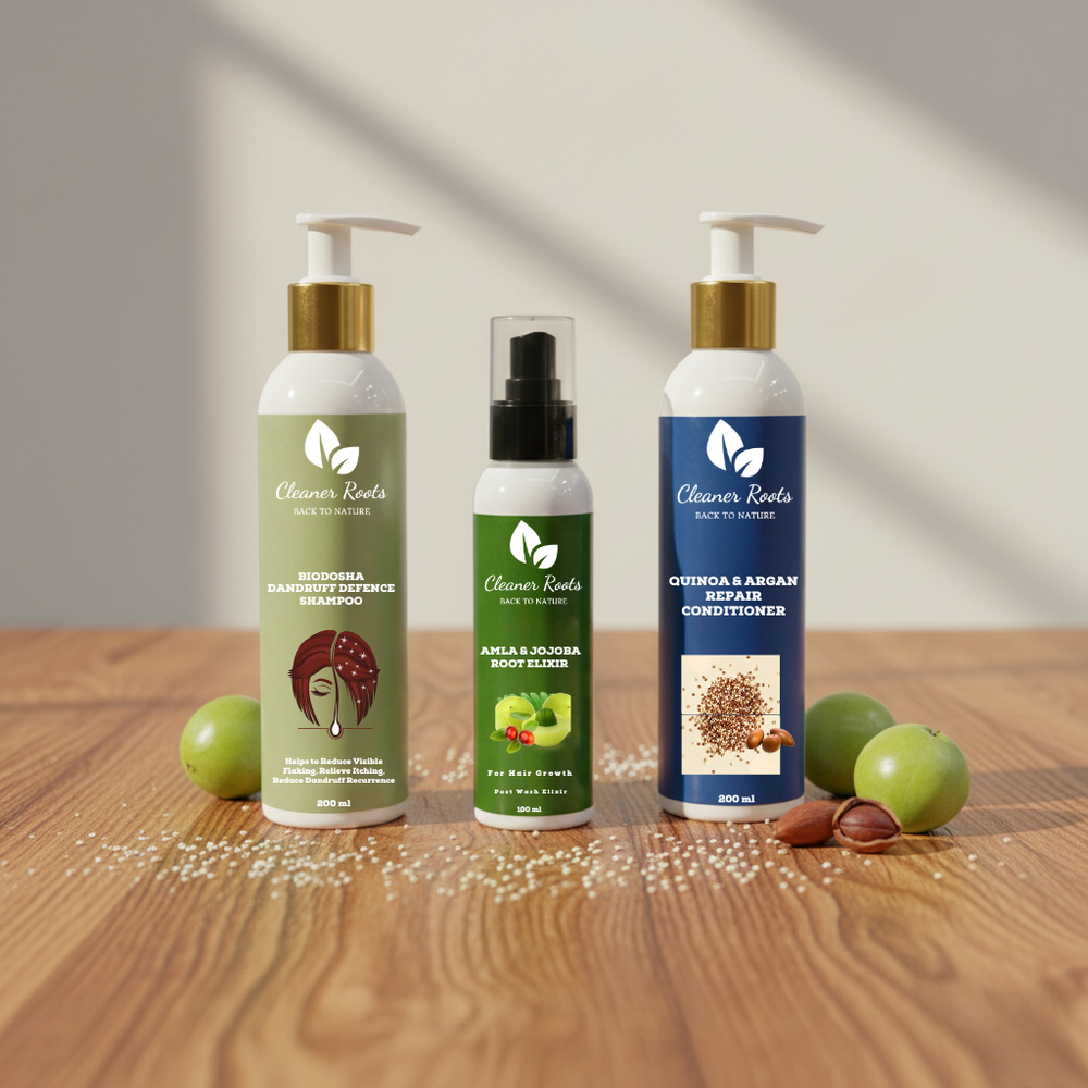 Three hair care products on a wooden surface with green apples and nuts.