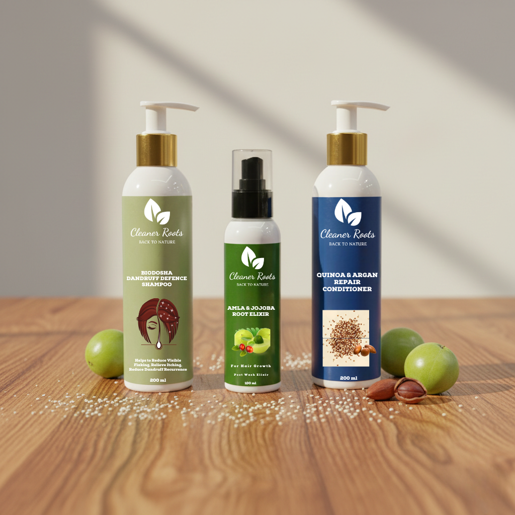 Three hair care products on a wooden surface with green apples and nuts.
