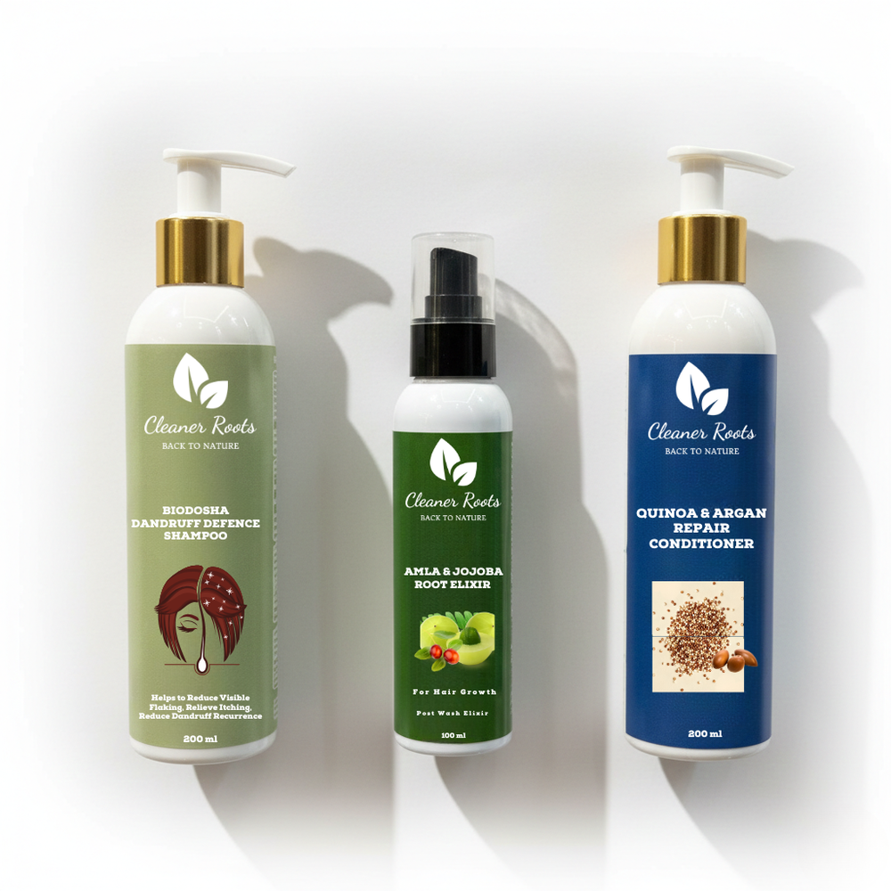 Three bottles of 'Cleaner Roots' hair care products on a white background