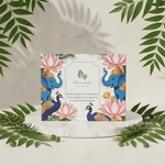 Product packaging with elephants, peacocks, and lotus flowers on a beige background