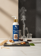 Shampoo bottle with a blue label on a white surface with ingredients and tools in the background