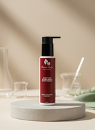 Red bottle with black pump on a beige surface