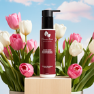 Body moisturizer bottle with pink tulips on a blue sky background