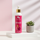 Tropical fruit body cleanser bottle with a potted plant on a white platform against a pink background